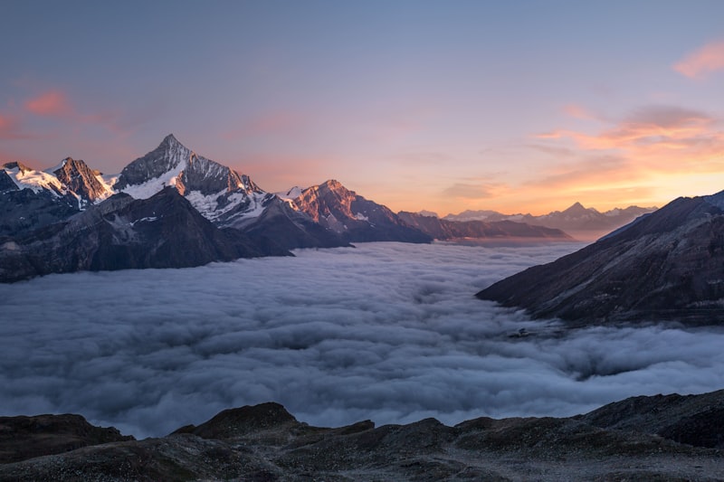 Person hiking in mountains at sunset